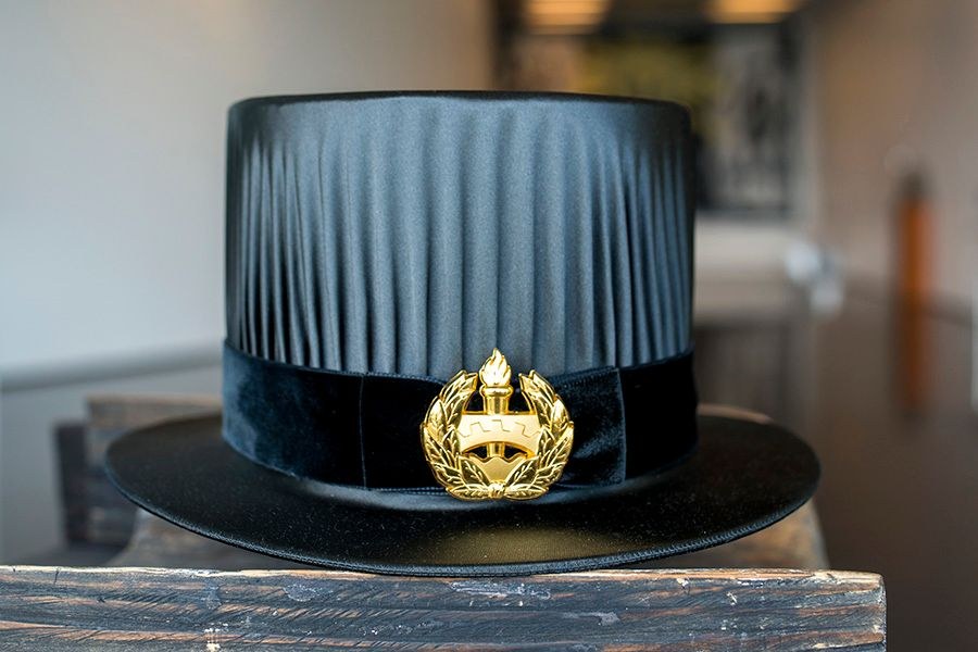 Doctoral hat with Tampere University's new emblem