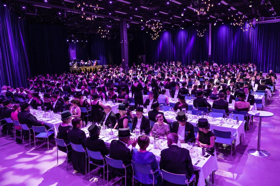 People sitting at long tables having dinner