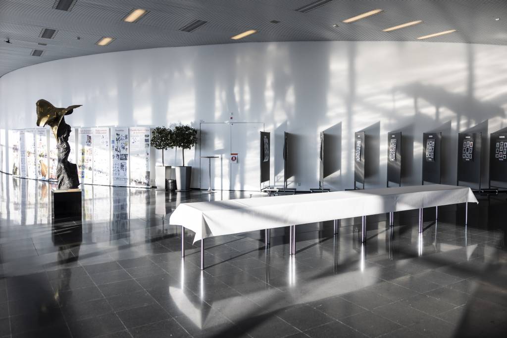 Tampere University conference hall with posters and startue.
