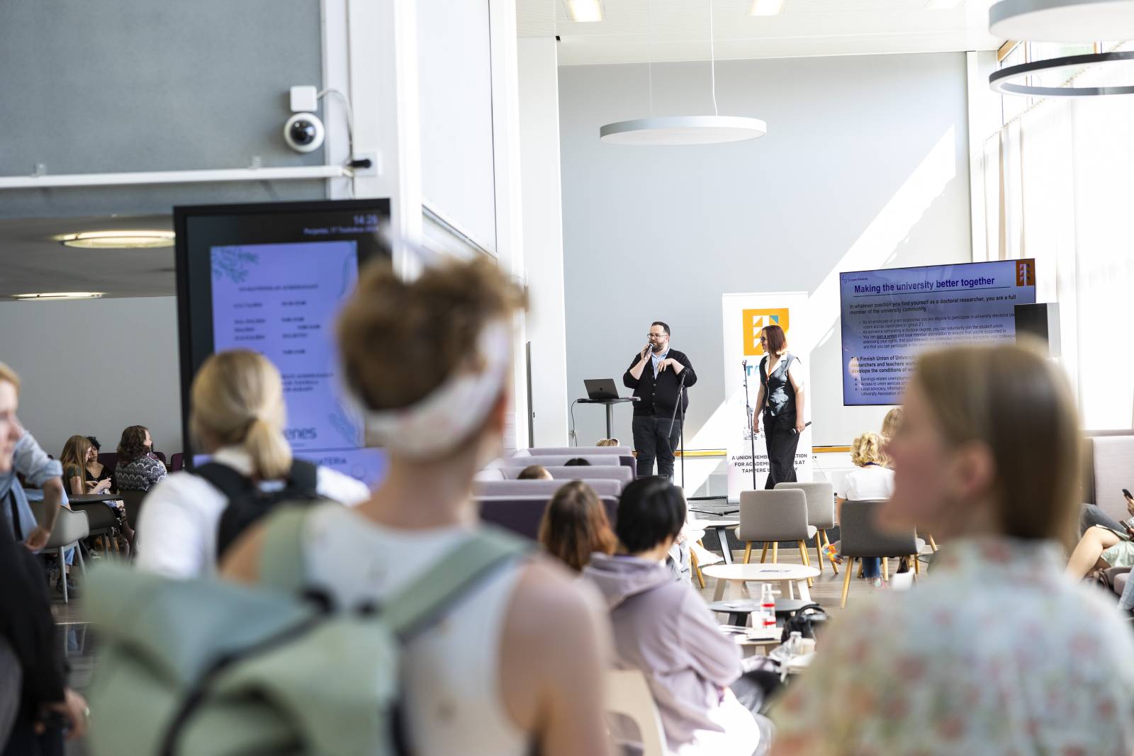 Presenters presenting and people listening