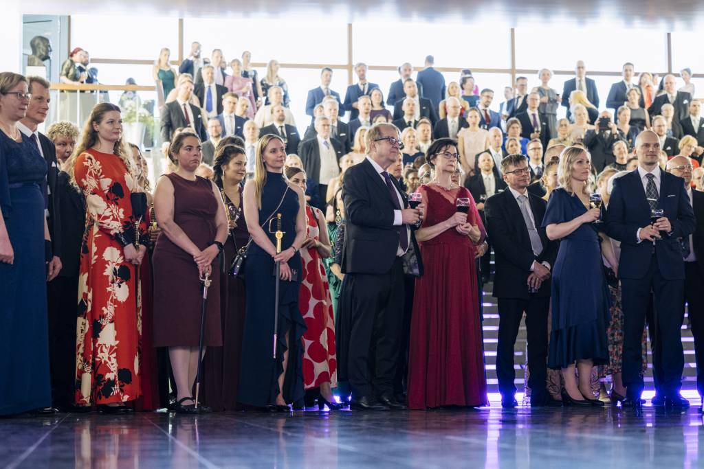 People listen to speeches at the pre-conferment celebration