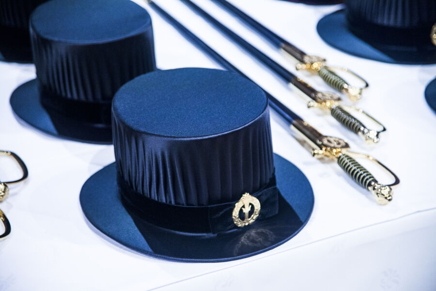 Doctoral hats and swords on a table