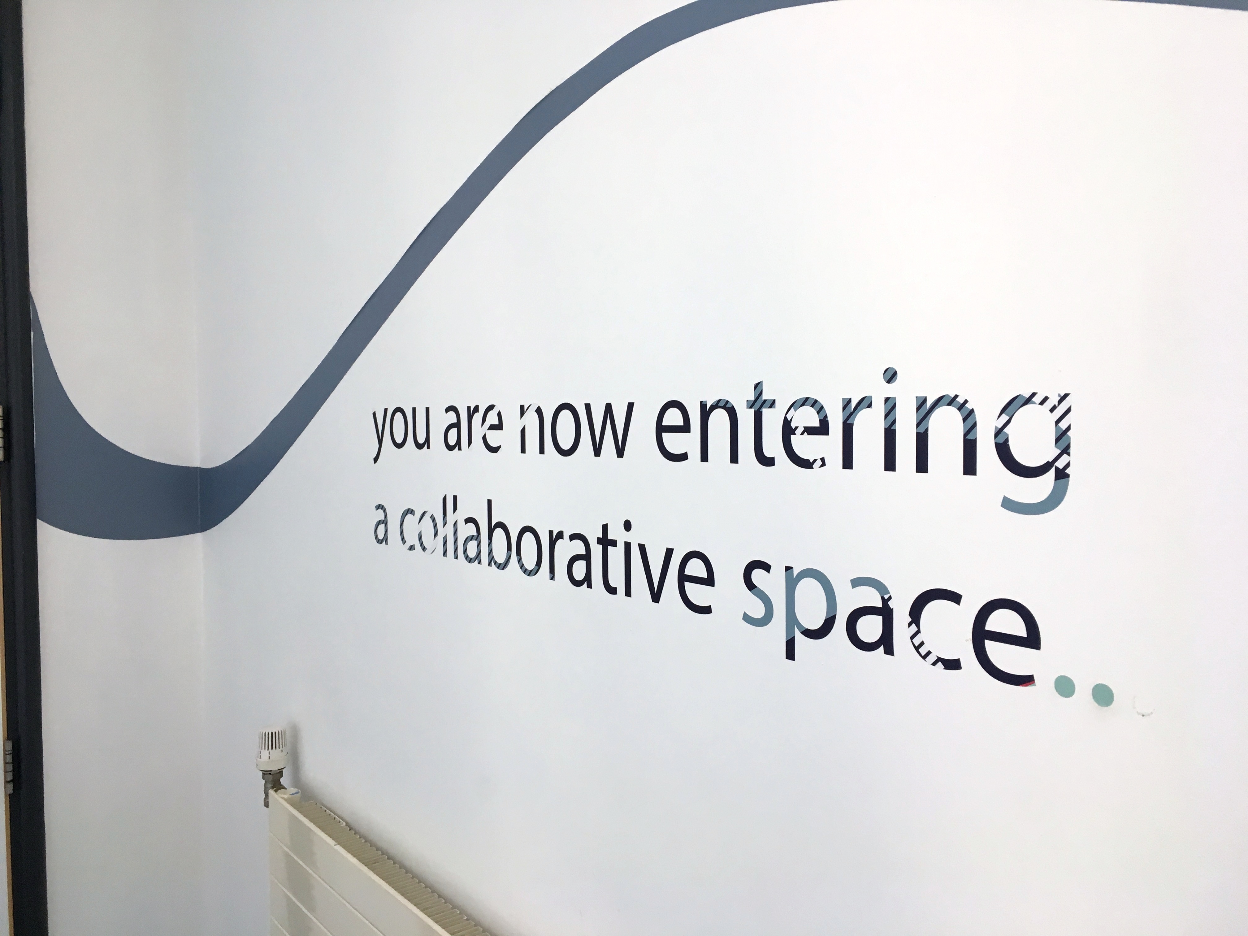 A picture of a wall with text "you are now entering a collaborative space". The photo is from Disruptive Media Learning Lab at Coventry University