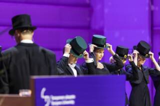 Doctors put on their doctoral hats